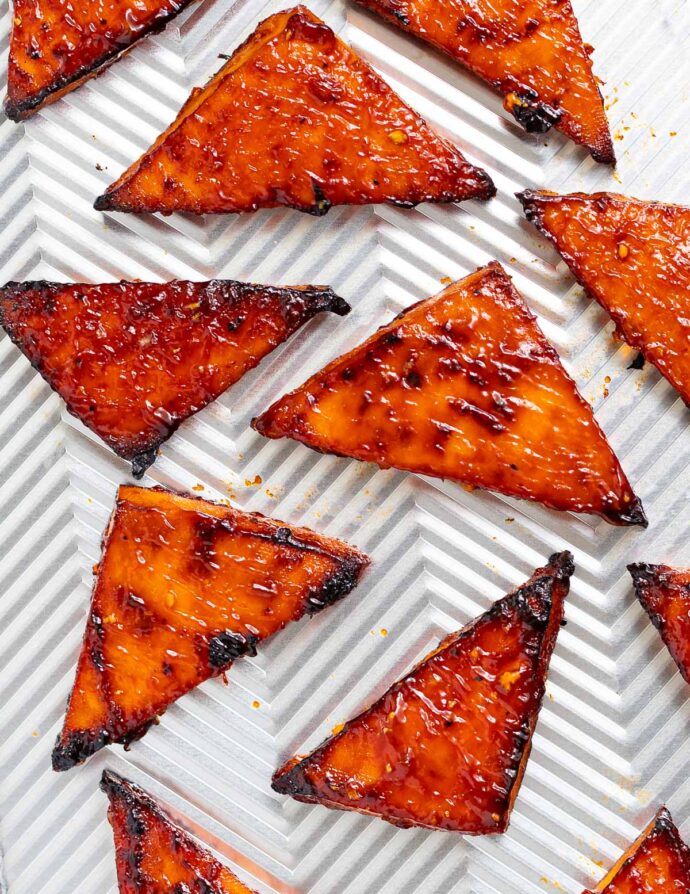 triangles of baked tofu on a baking tray