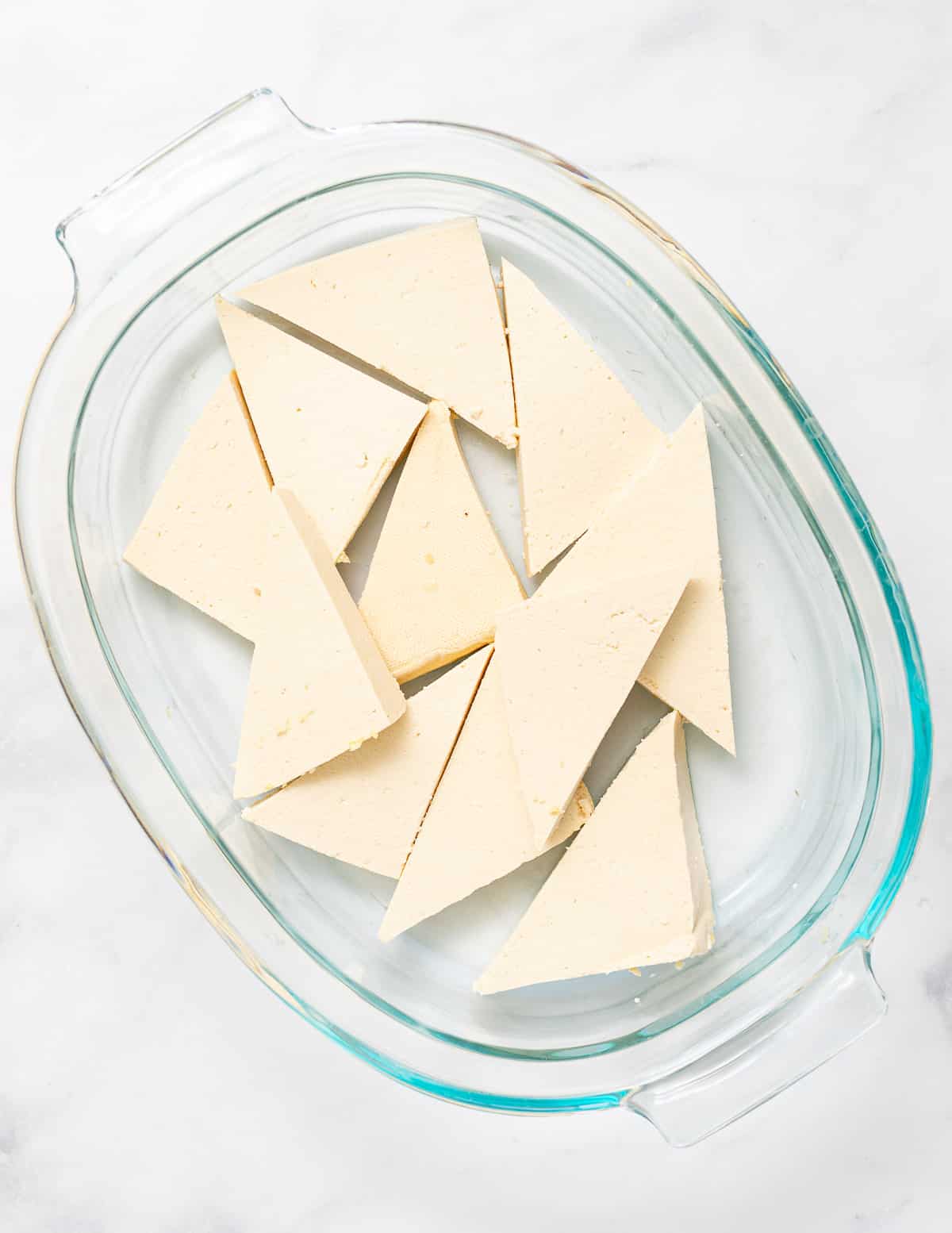 triangles of tofu in a pyrex dish 