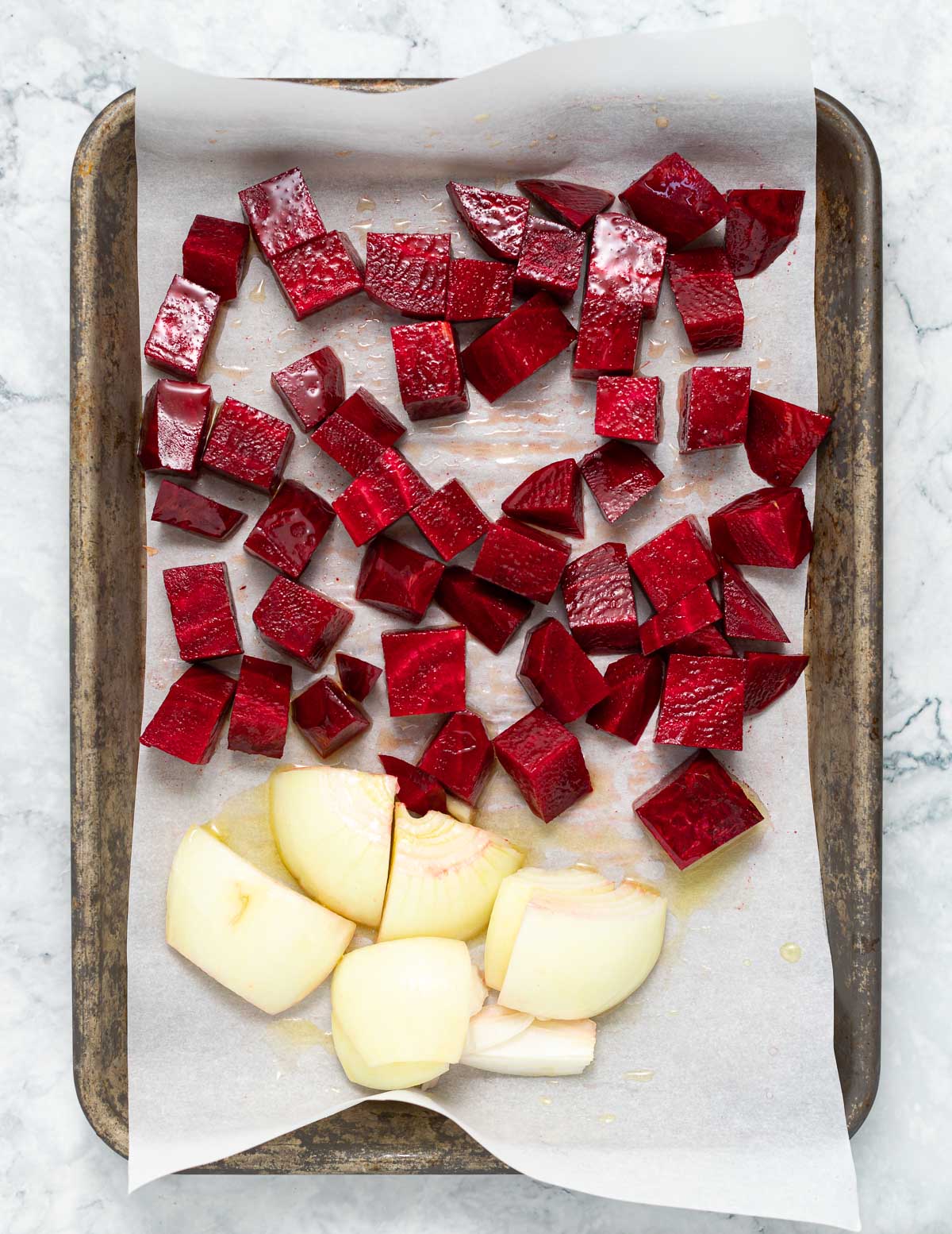 beets and onion on a baking tray