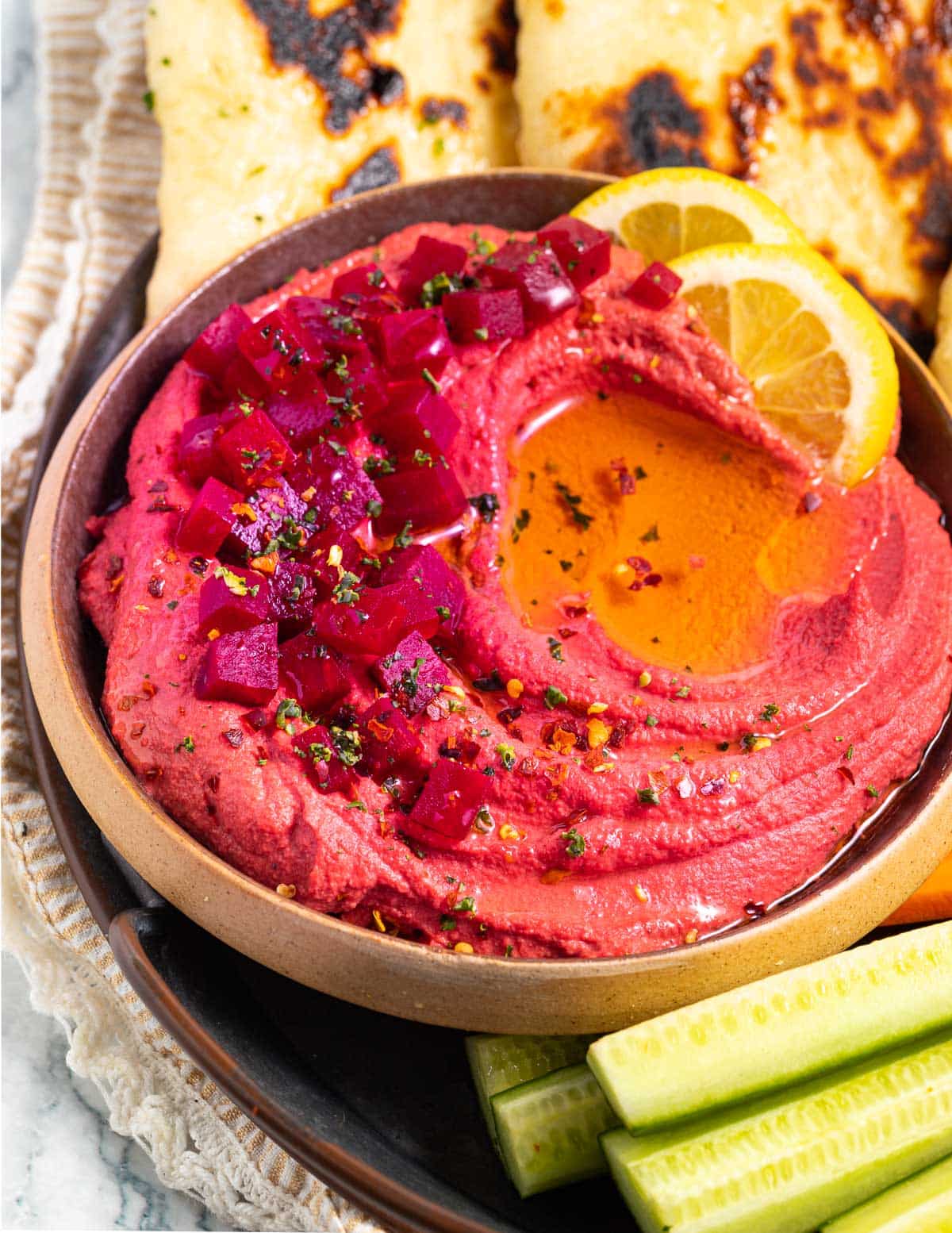 beet hummus in abowl topped with cubed beets & olive oil
