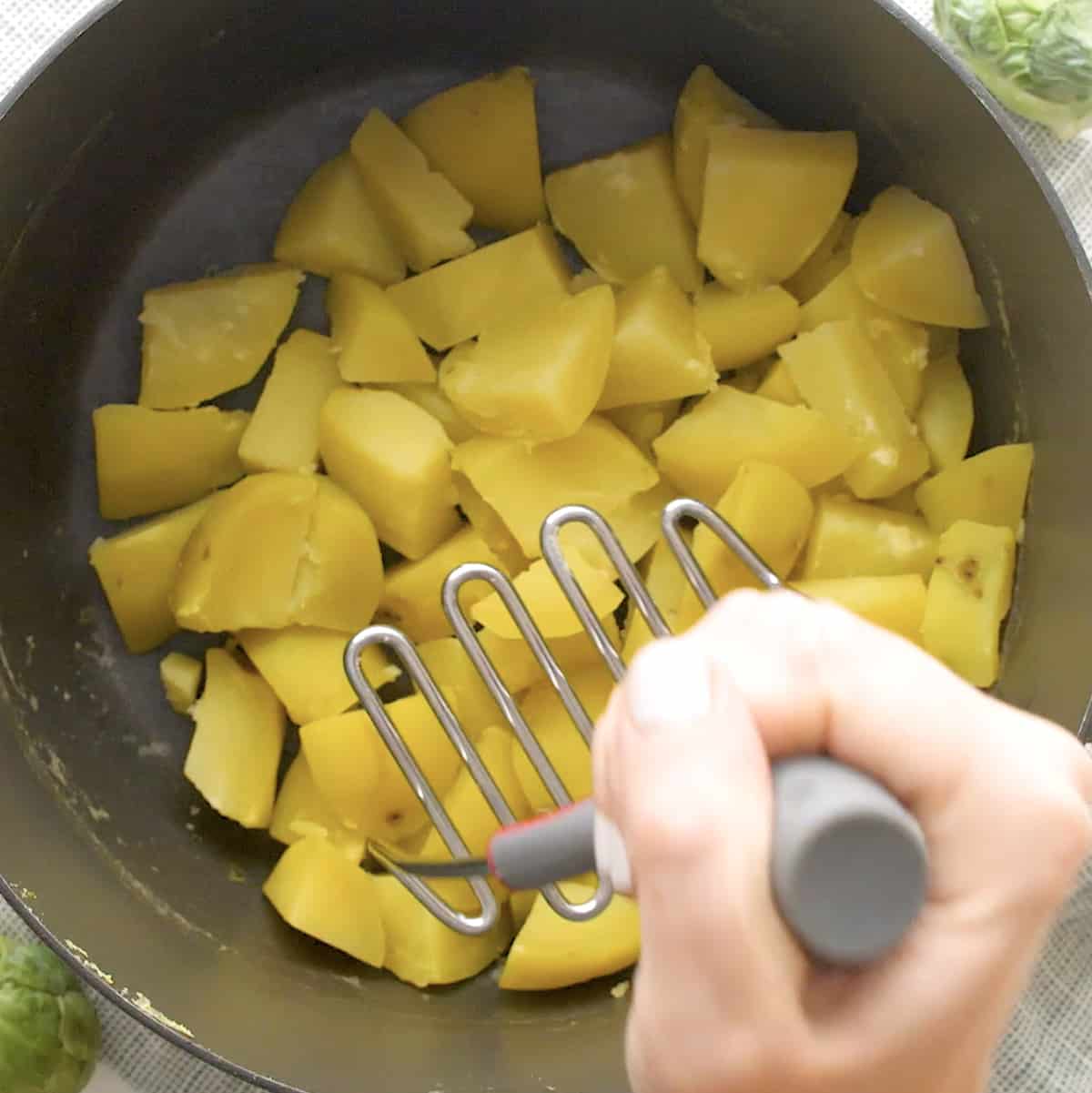 potatoes being mashed 