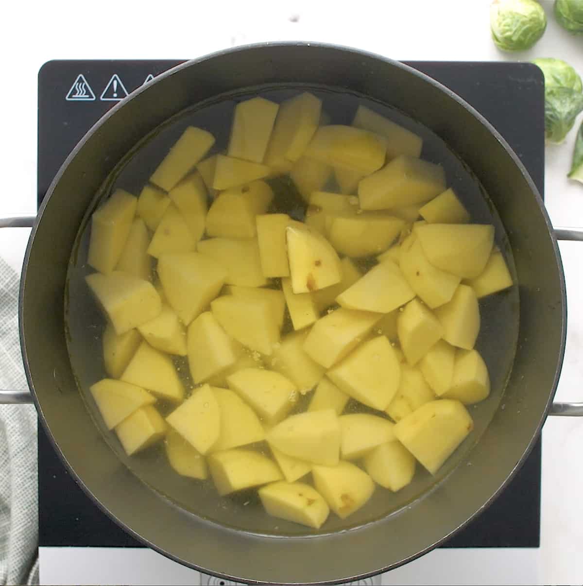 cubed potatoes in a pan of water