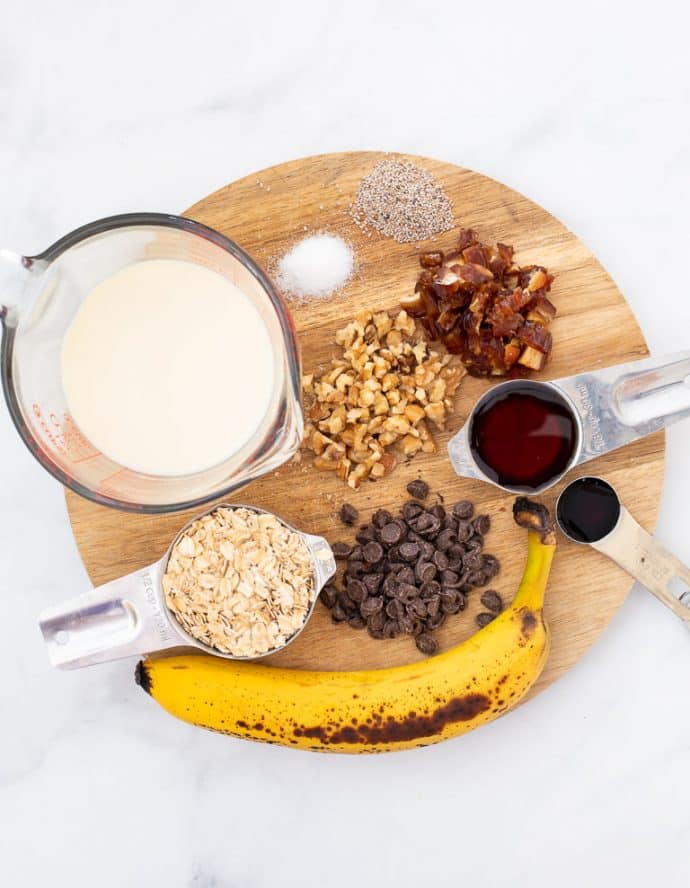 Ingredients for Chunky Monkey Overnight Oats laid out on a board