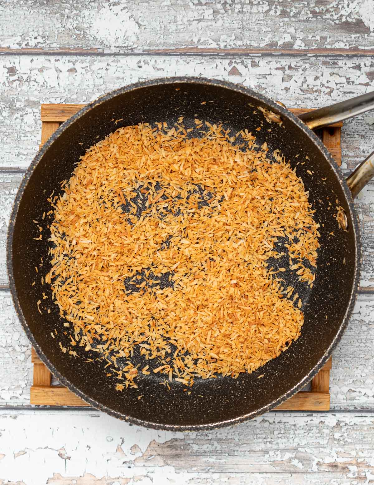 shredded coconut toasting in a pan