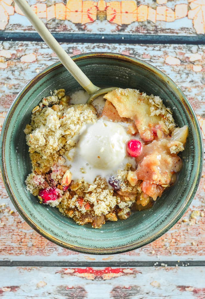 Overhead shot of Cranberry Apple Pear Vegan Crumble topped with melty ice cream