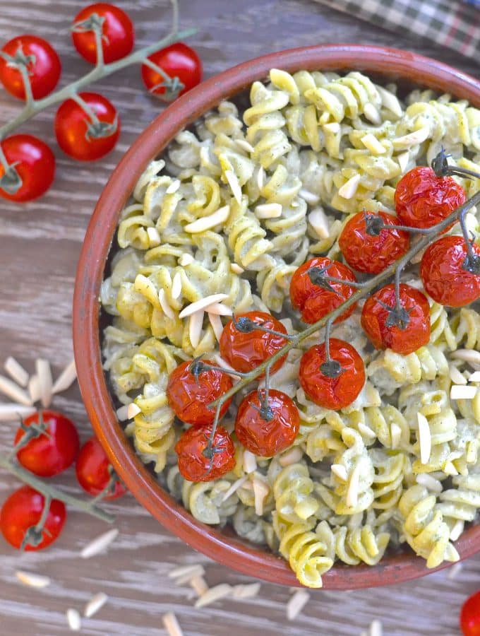 A simple but incredibly delicious, super creamy Vegan Pesto Pasta Salad topped with juicy, sweet, oven roasted tomatoes. It has just 5 ingredients & is ready in the time it takes to roast the tomatoes!