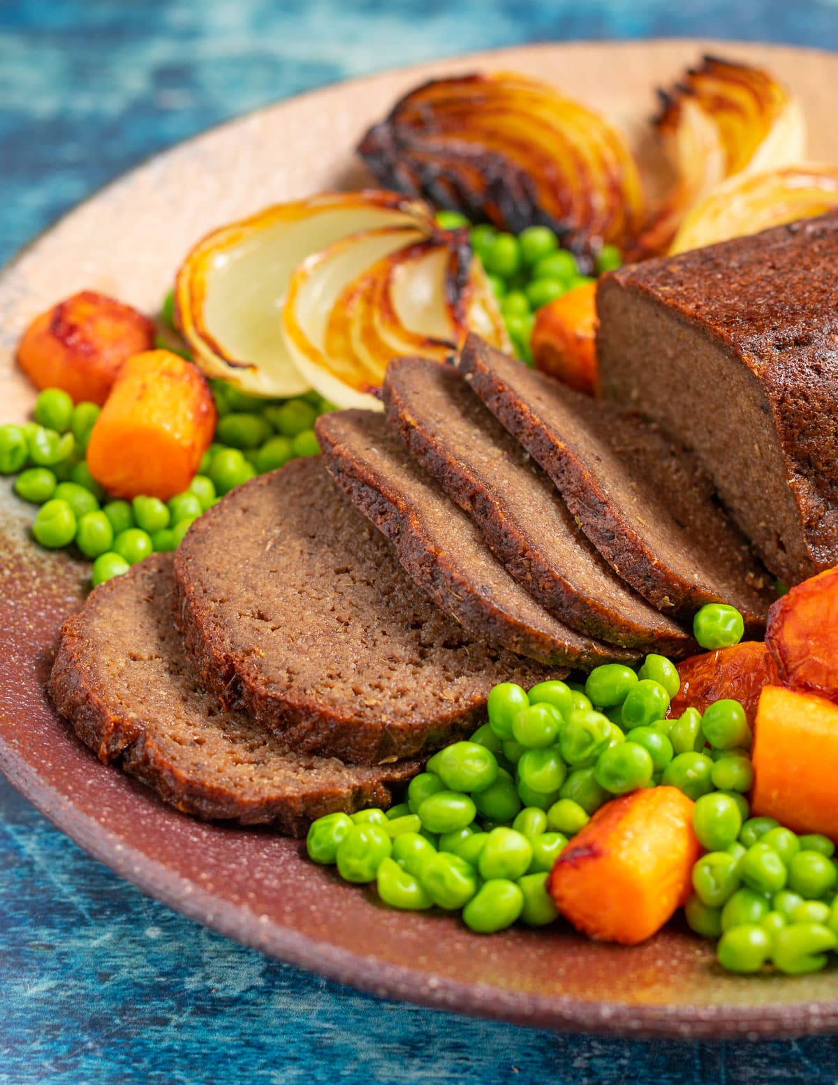 a sliced vegan and gluten-free roast with vegetables