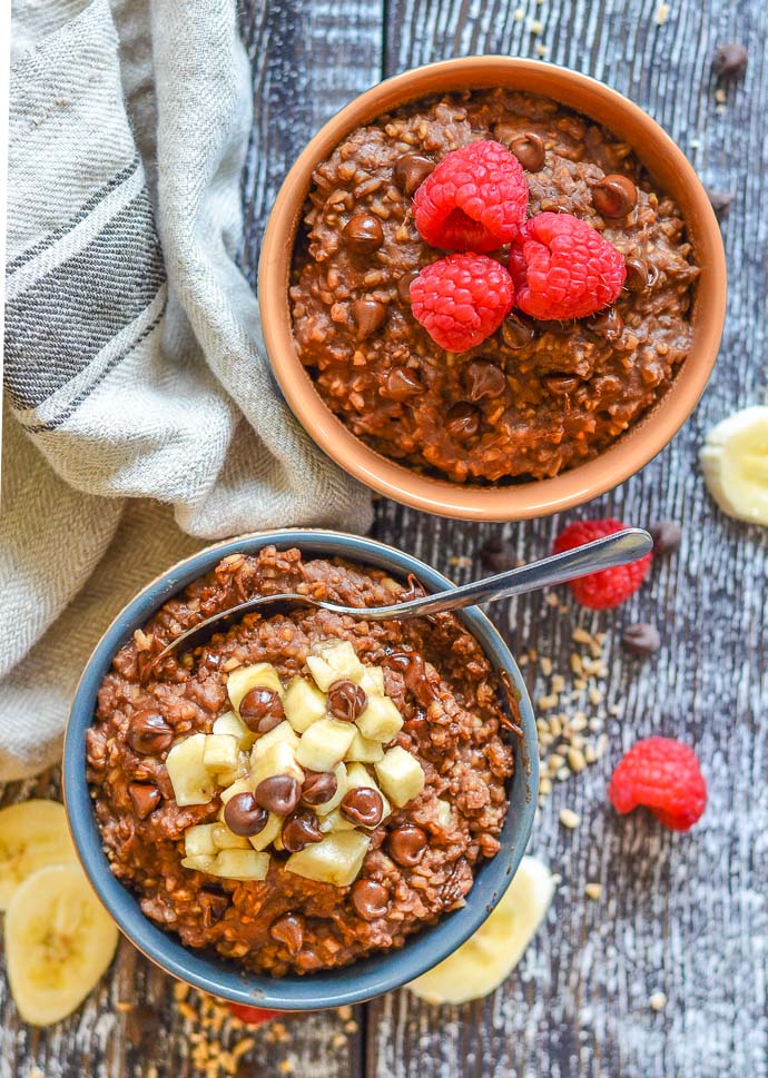 Healthy Chocolate Instant Pot Steel Cut Oats in bowls and topped with fruit and chocolate chips. Photo taken from above.