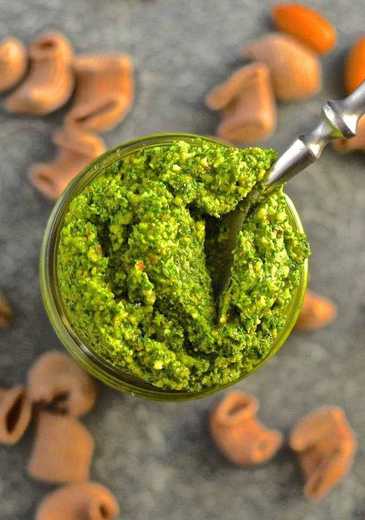 Kale Almond Vegan Pesto in a jar with a spoon in, taken from above 