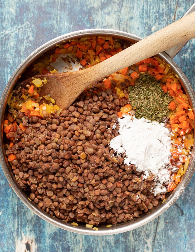 lentils, arrowroot, herbs, carrots, onions and garlic in a pan