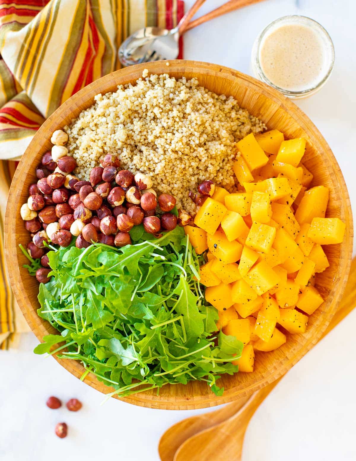 all of the salad components in a wooden bowl