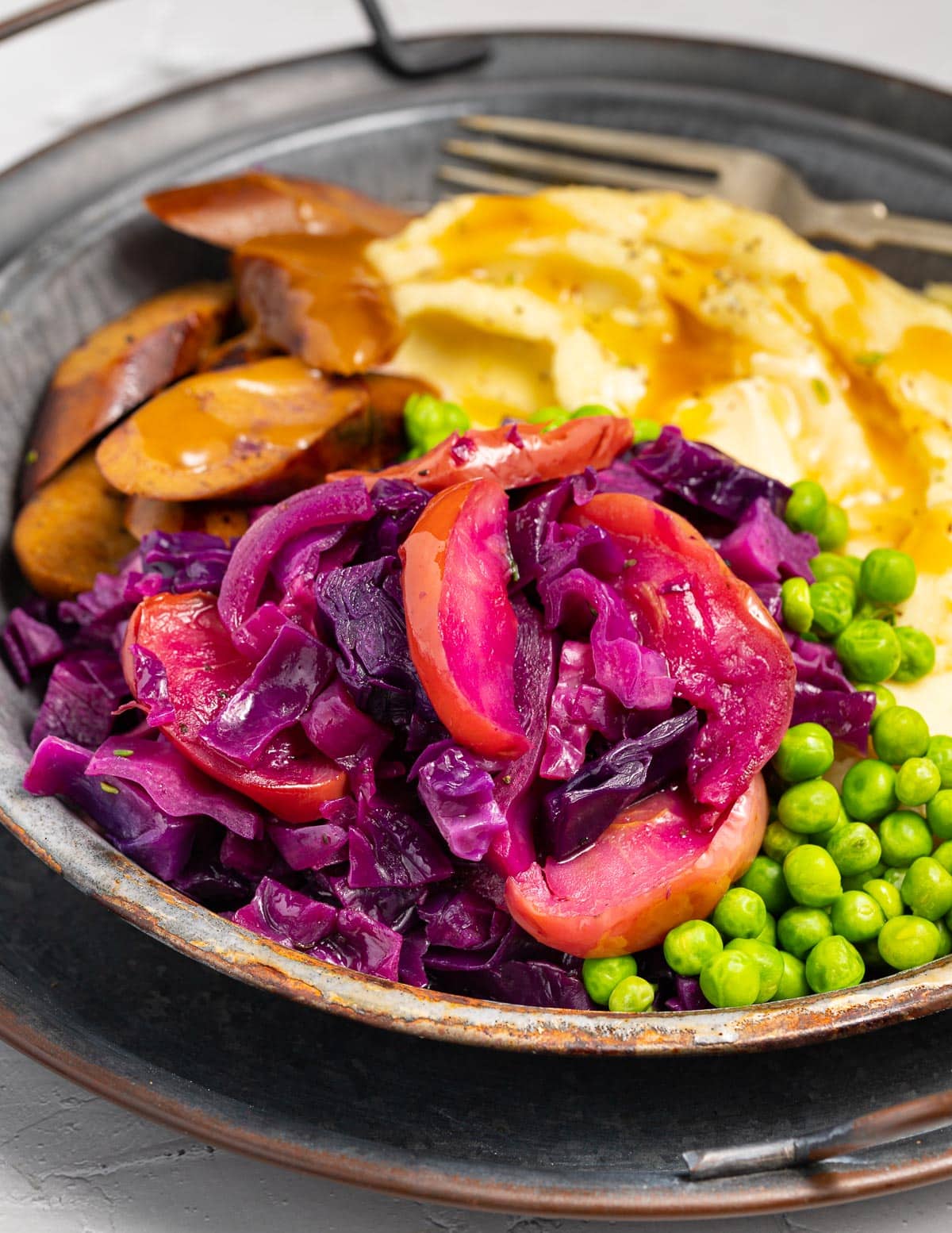 roasted red cabbage and apples with sausage and mashed potato 
