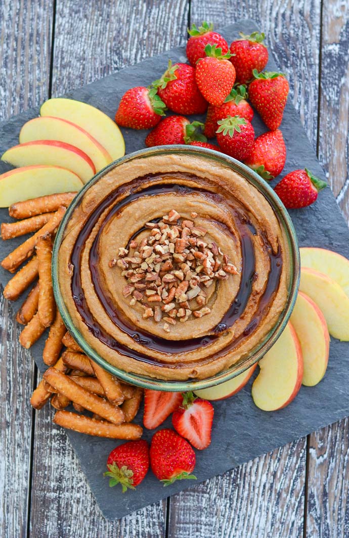 Snickerdoodle Dessert Hummus from above, surrounded with fruit and pretzels for dipping