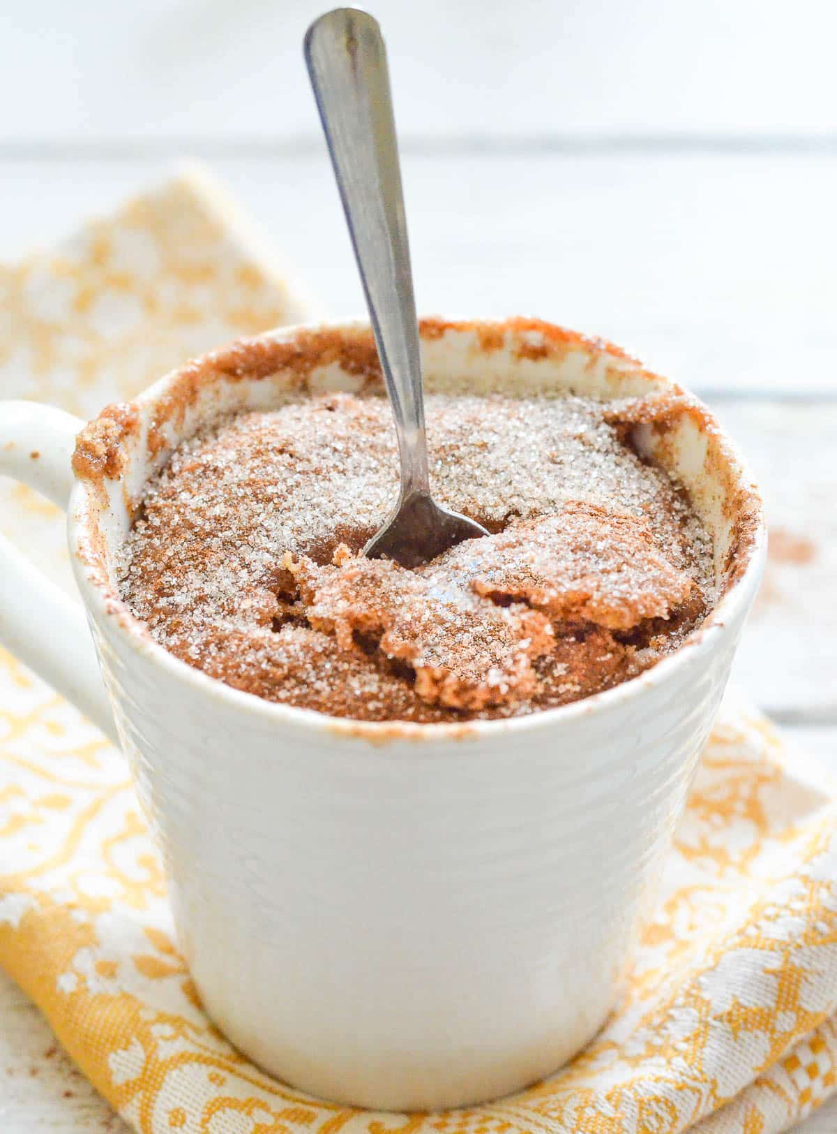 a mug cake with a spoon in it 
