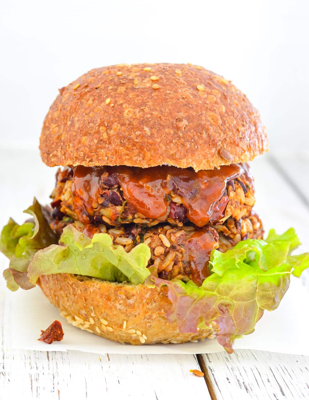 rice and red bean burgers in a bun with lettuce and sauce