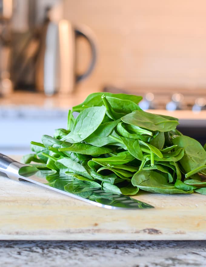spinach on a cutting board
