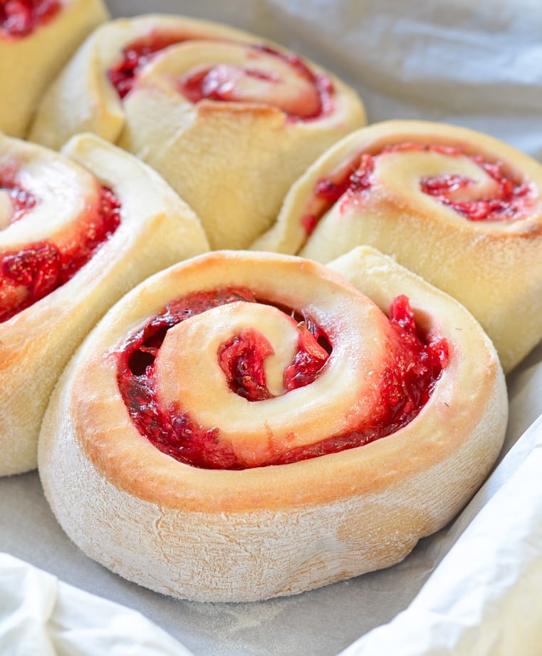 Strawberry Rolls fresh from the oven in a parchment paper lined pan. 