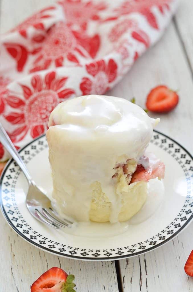 Strawberry Sweet Roll Vegan Mug Cake on a plate with white frosting