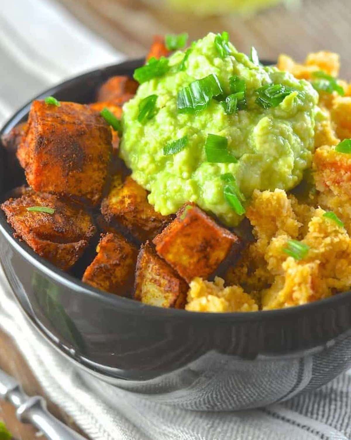 close up of roasted sweet potatoes on a cauliflower rice bowl