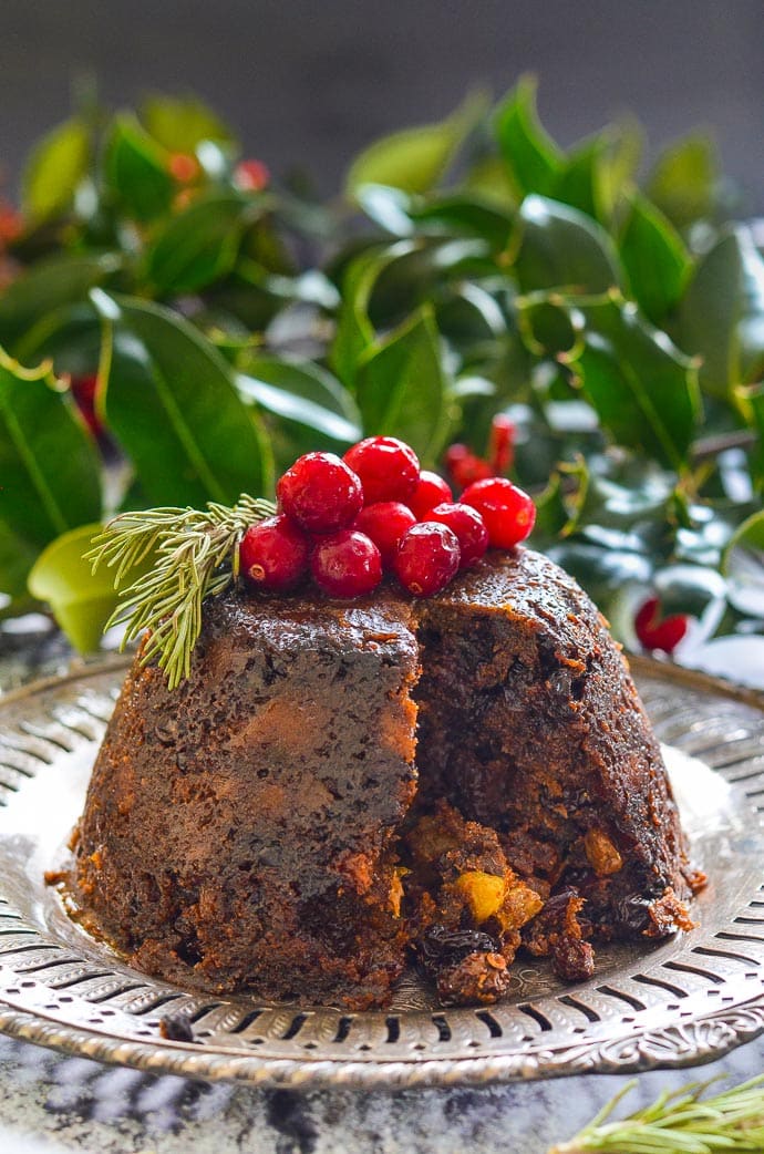 Vegan Christmas Pudding with a wedge cut out and inside showing.