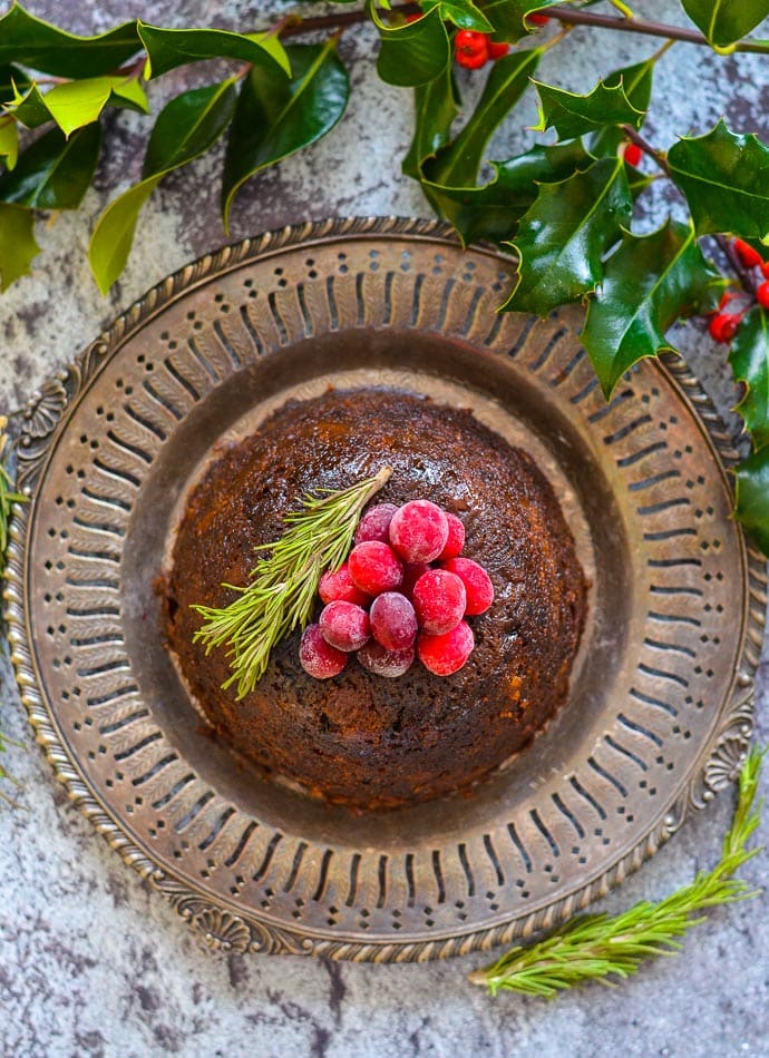 Vegan Christmas Pudding on bronze metal plate, shot taken from above