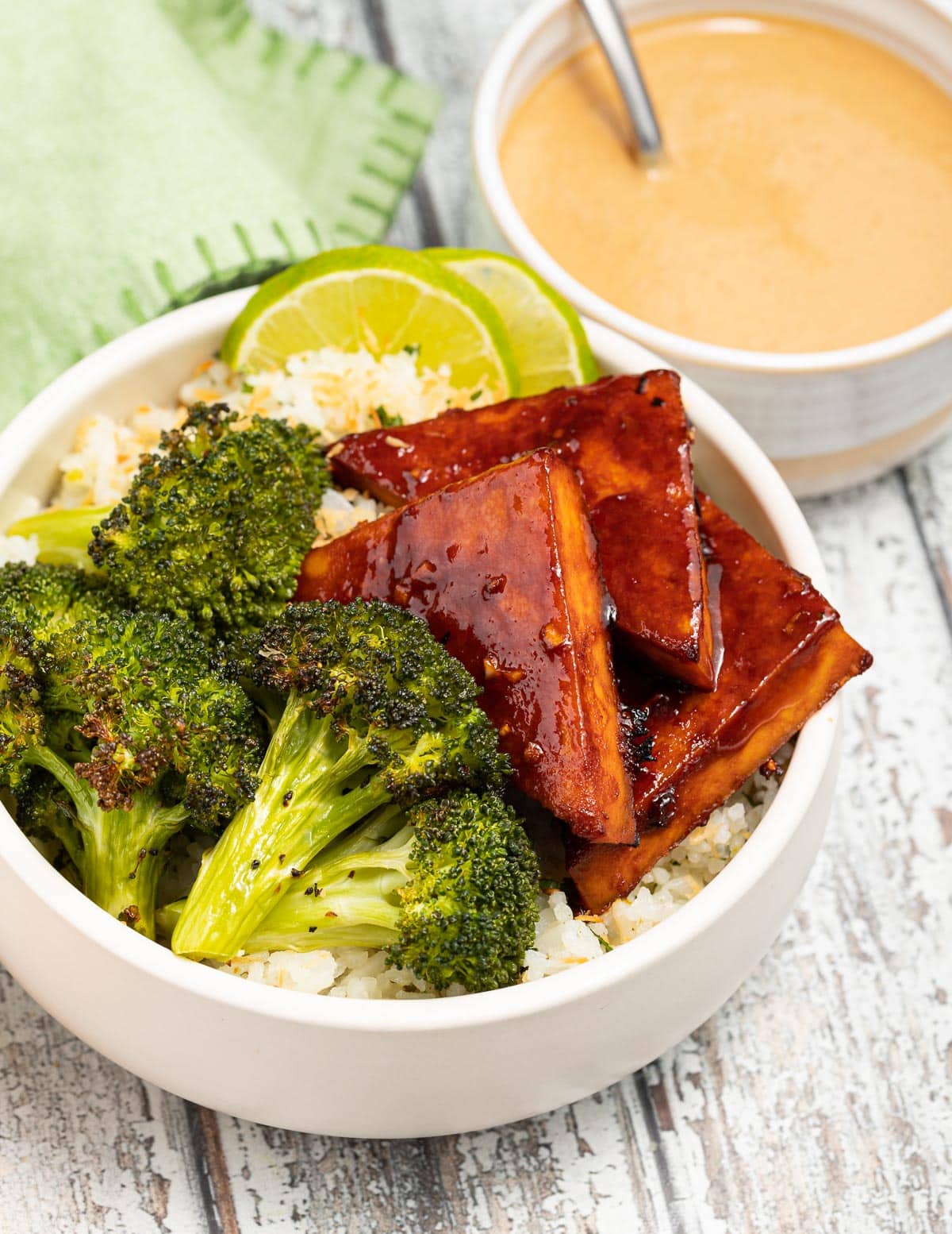 a bowl with rice, broccoli and tofu