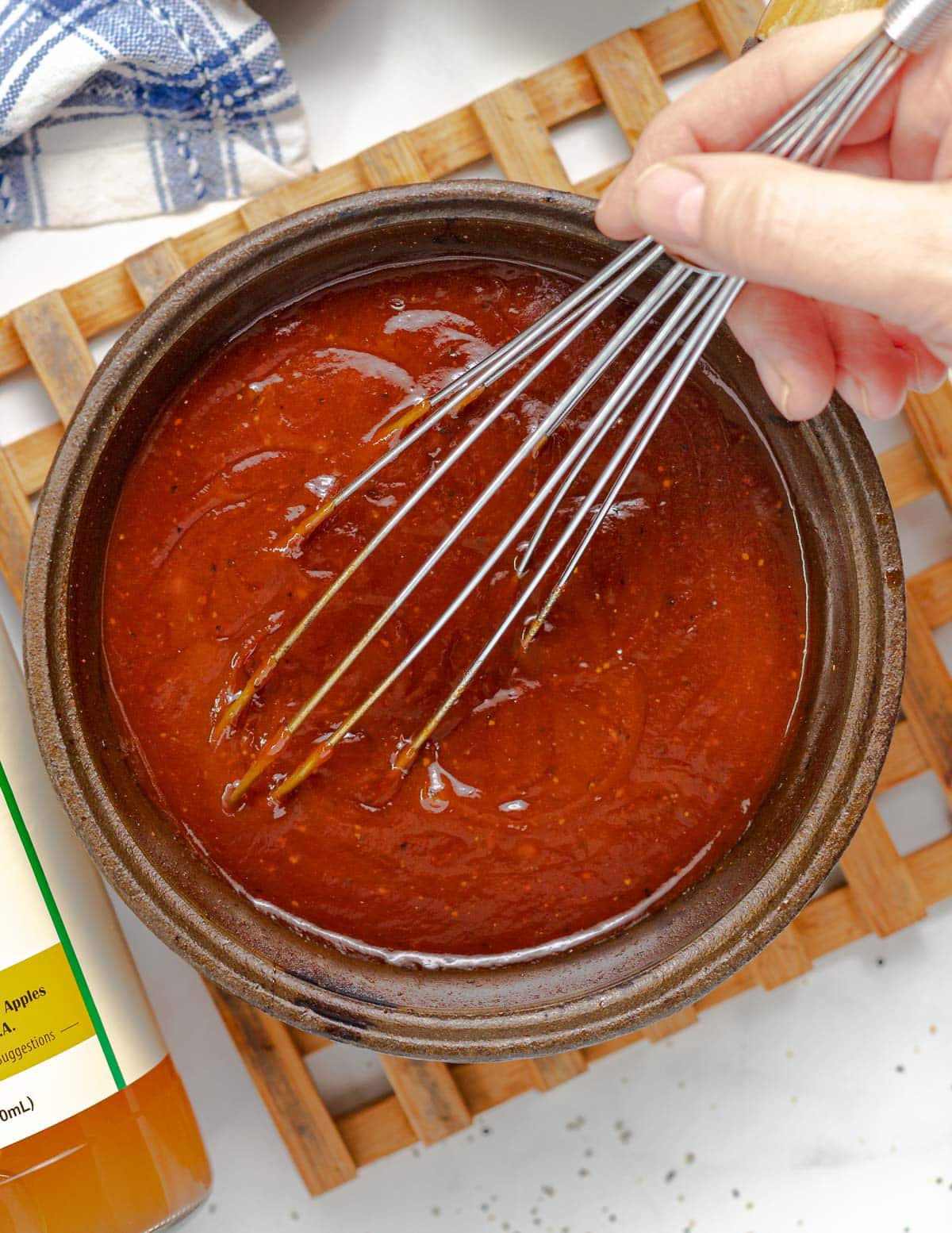 whisking BBQ sauce in a pan