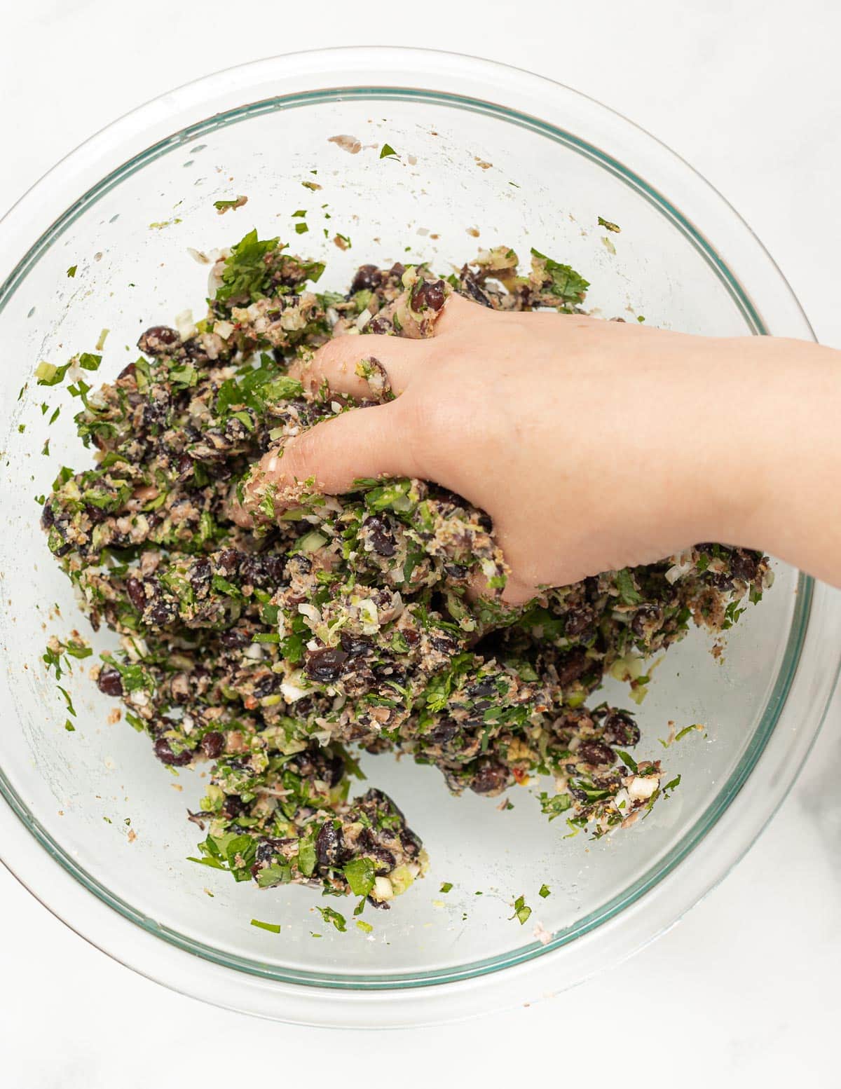 mixing bean burger ingredients with hands