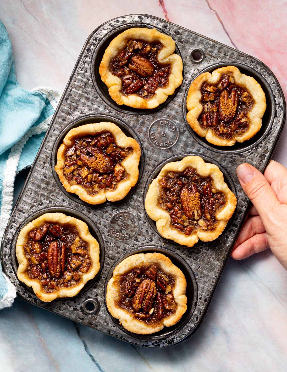 a vintage muffin pan filled with vegan butter tarts