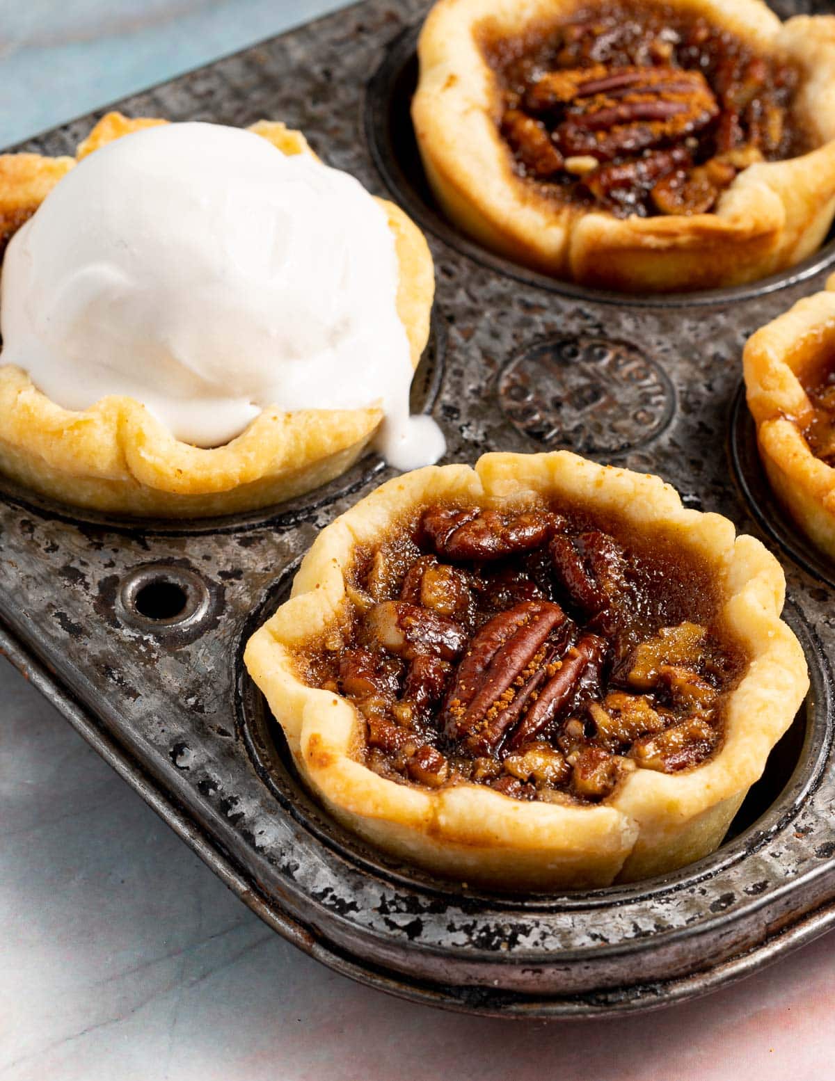 butter tarts in a pan, one topped with ice cream
