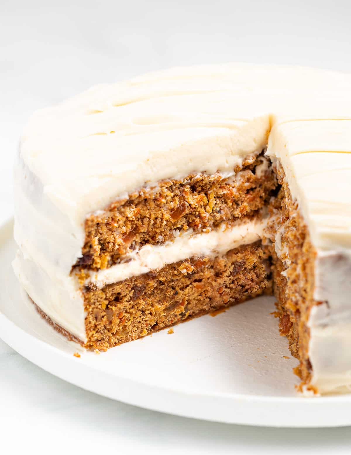 a carrot cake with a big slice taken out so inside is visible