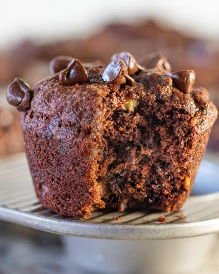 a vegan chocolate banana muffin with a bite taken out