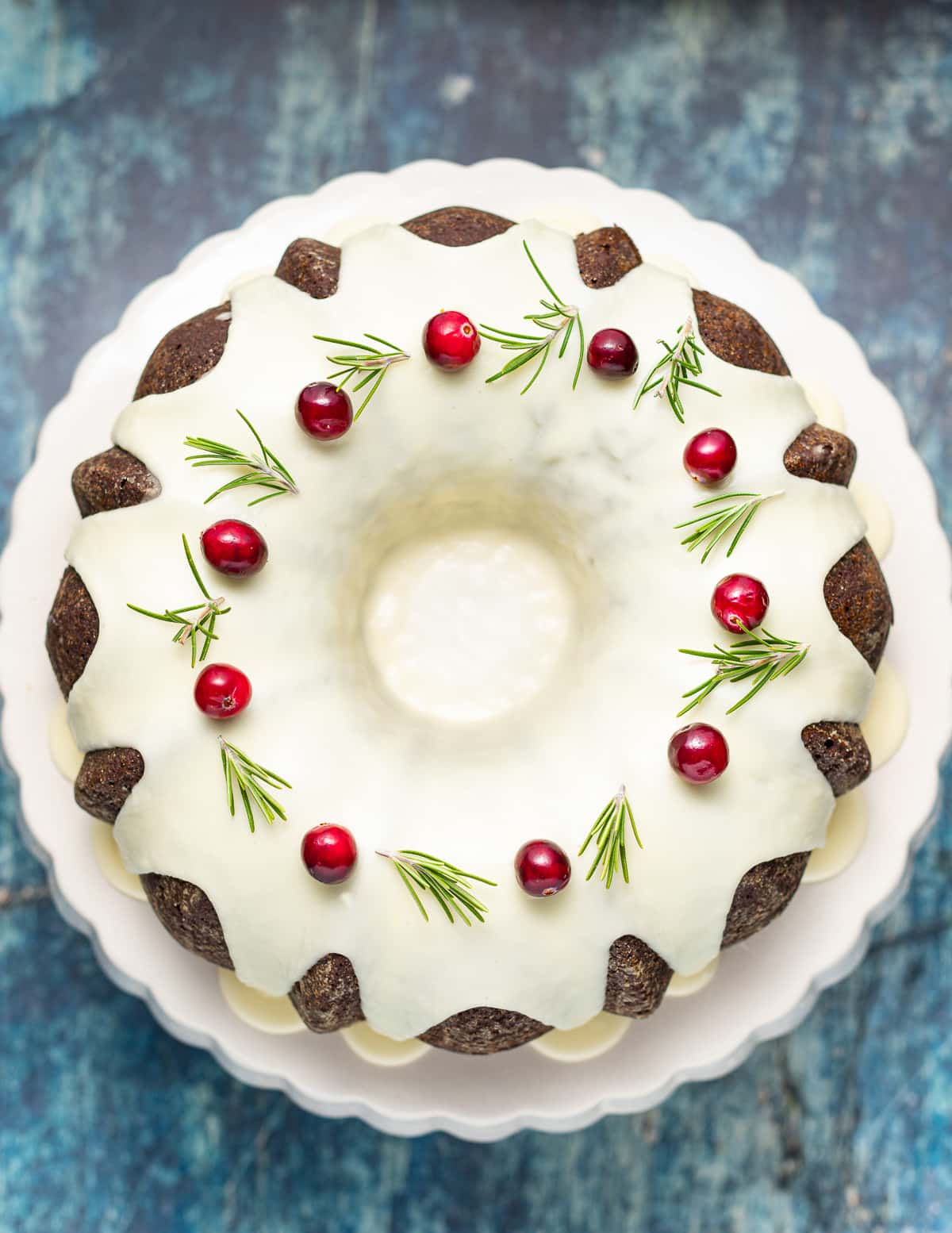 a vegan gingerbread cake with glaze and fresh cranberries