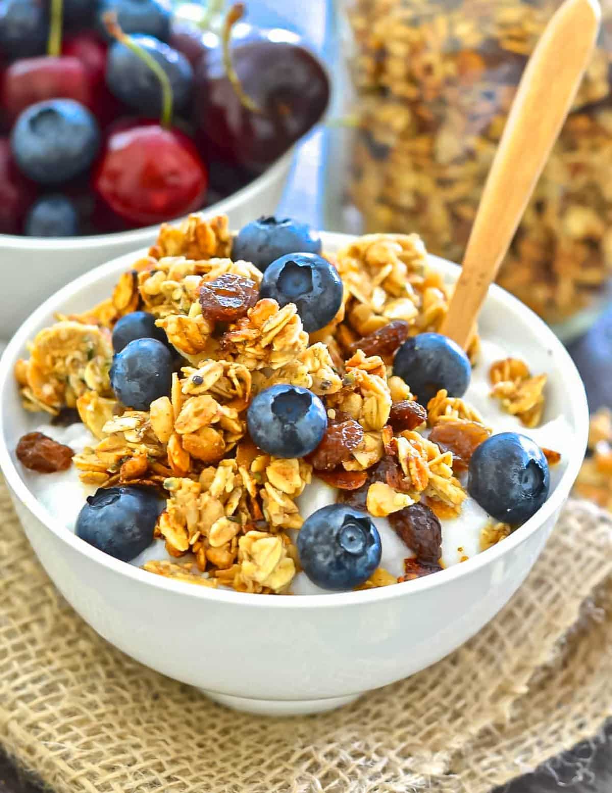 a bowl of vegan granola with yogurt and berries