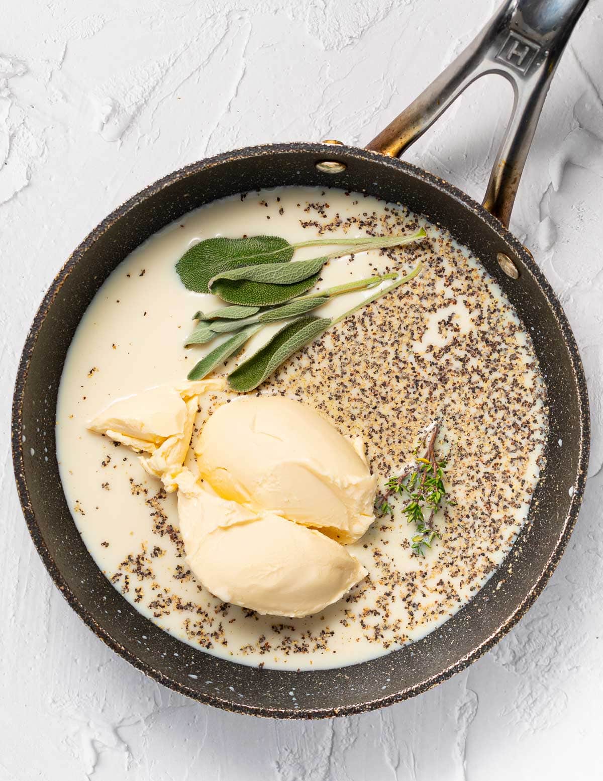 soy milk, vegan butter, pepper and herbs in a pan