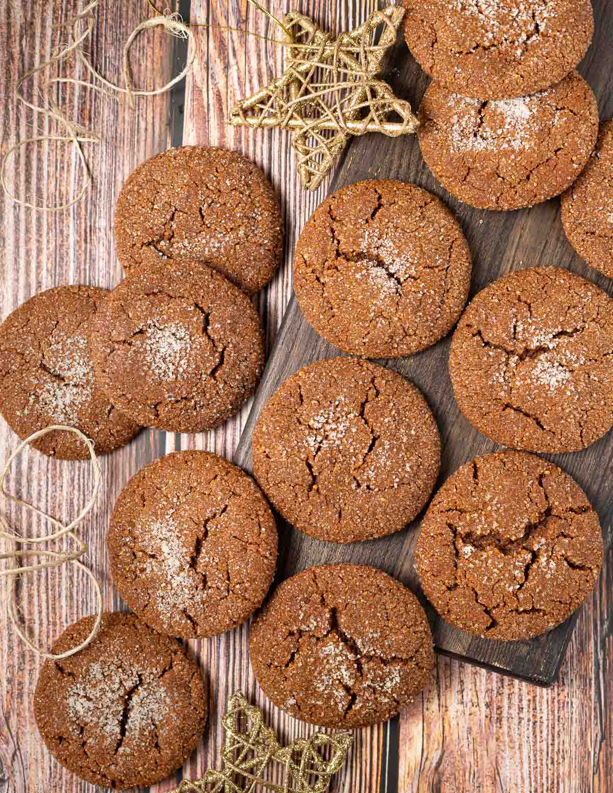 molasses cookies on a wooden board with star ornaments