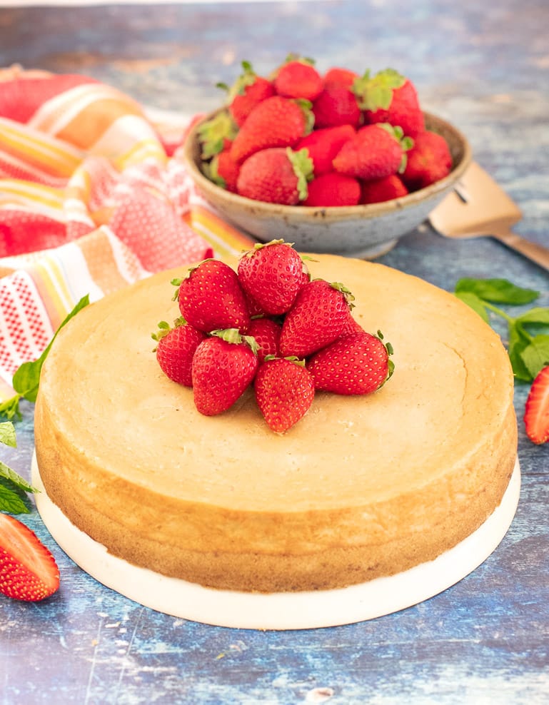 Vegan New York Cheesecake topped with fresh strawberries