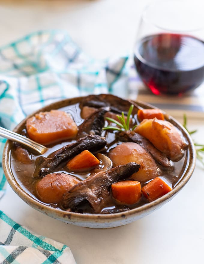 Vegan Instant Pot Portobello Pot Roast served in a bowl with a sprig of fresh rosemary 