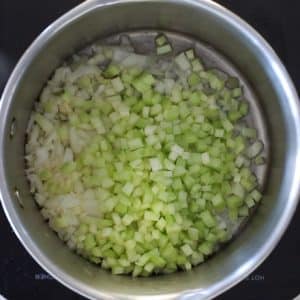 celery and onion sautéing in a pan - ready to make vegan potato soup