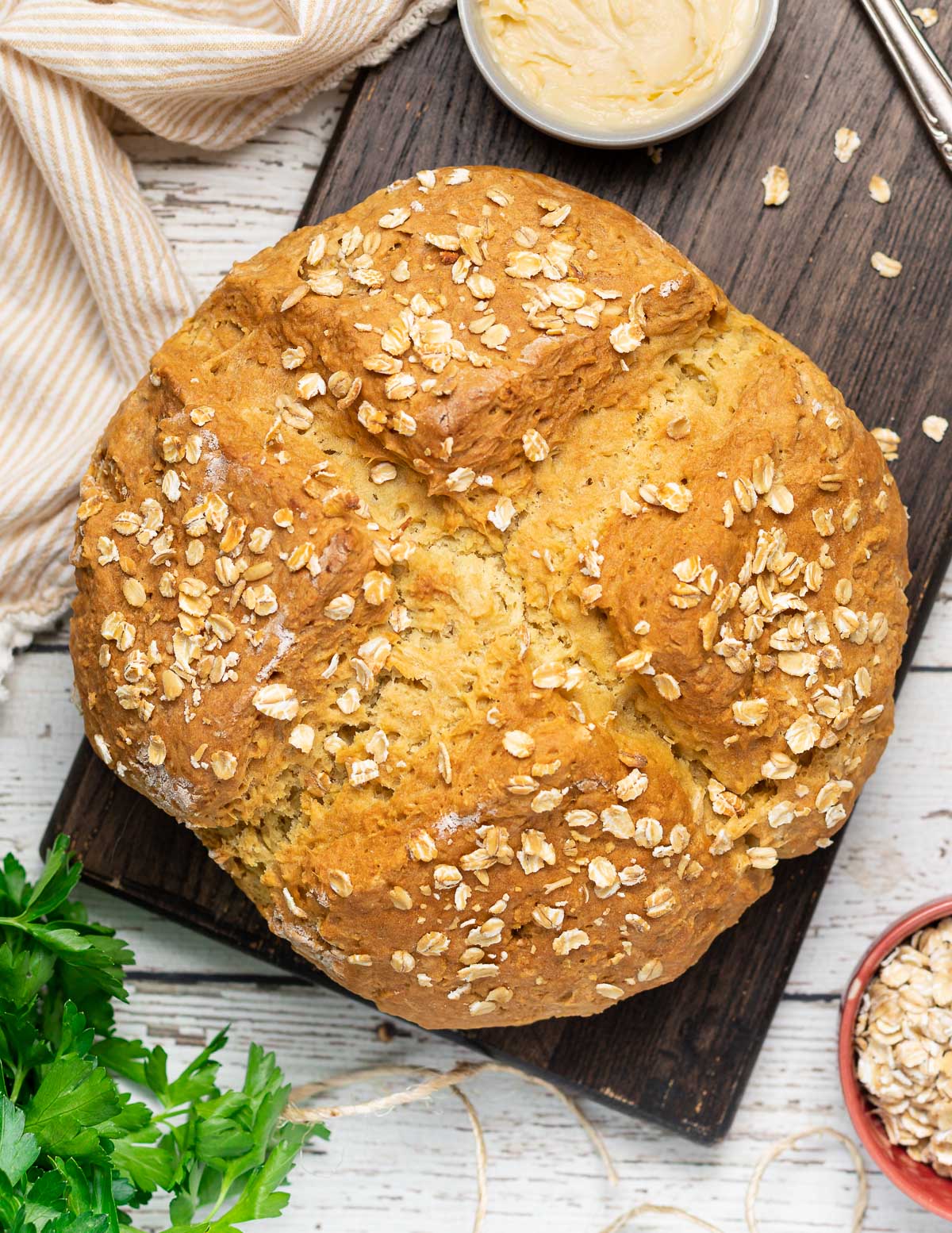 a golden loaf of oat sprinkled soda bread