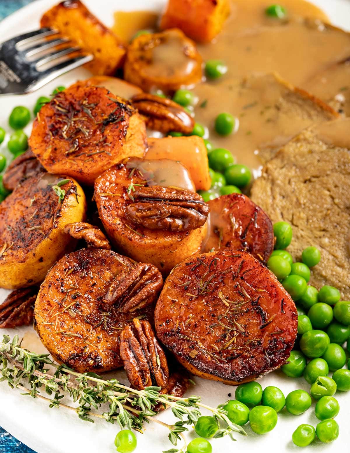sweet potatoes with pecan nuts on a plate with peas