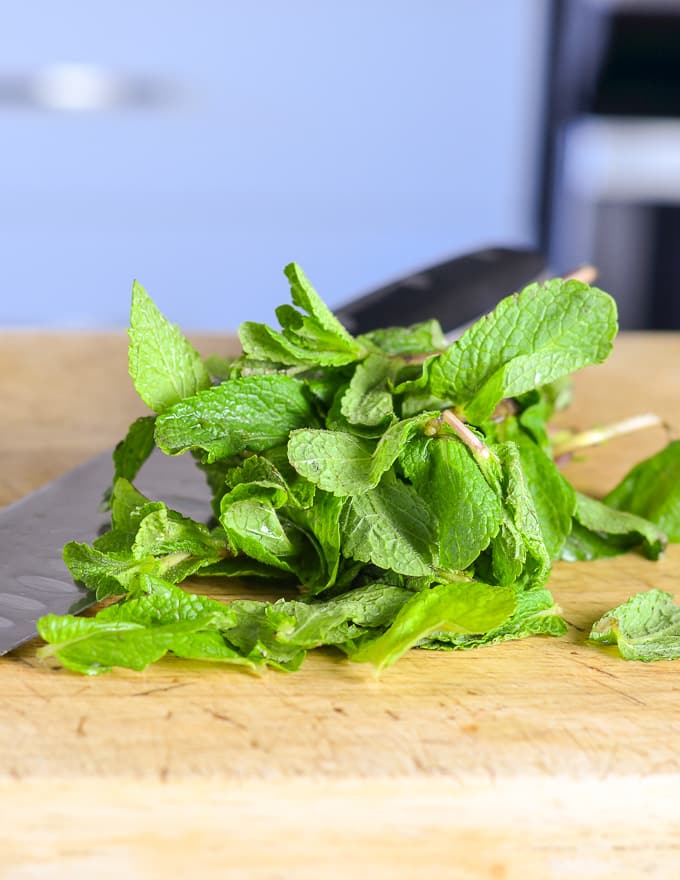mint on a board ready to be chopped for a Watermelon Mint Salad